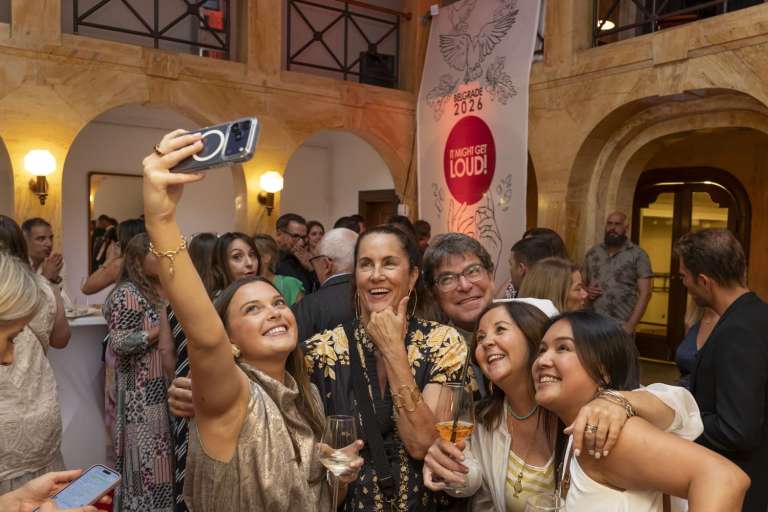 International guests taking a selfie and smiling together during the networking cocktail reception in the Kolarac Endowment atrium