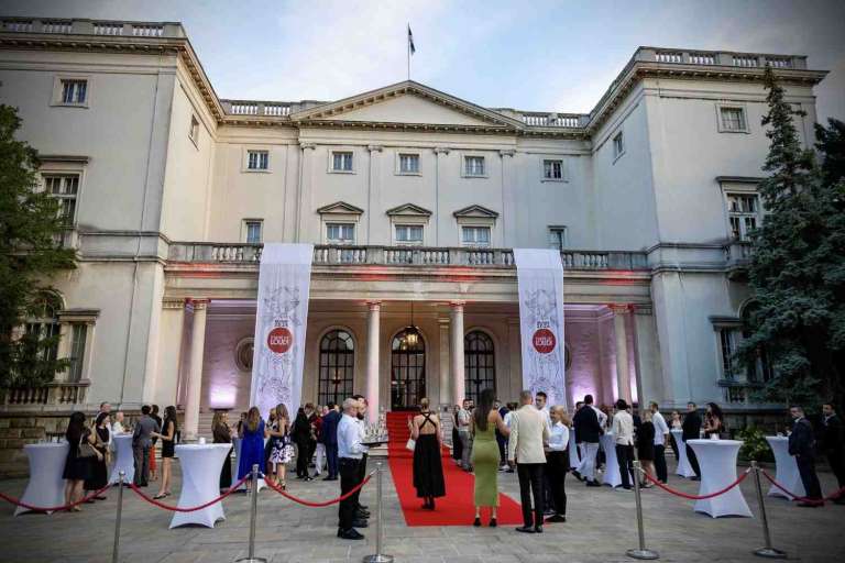 Guests arriving on the red carpet at the entrance of the White Palace for the IMGL 2026 gala event in Belgrade