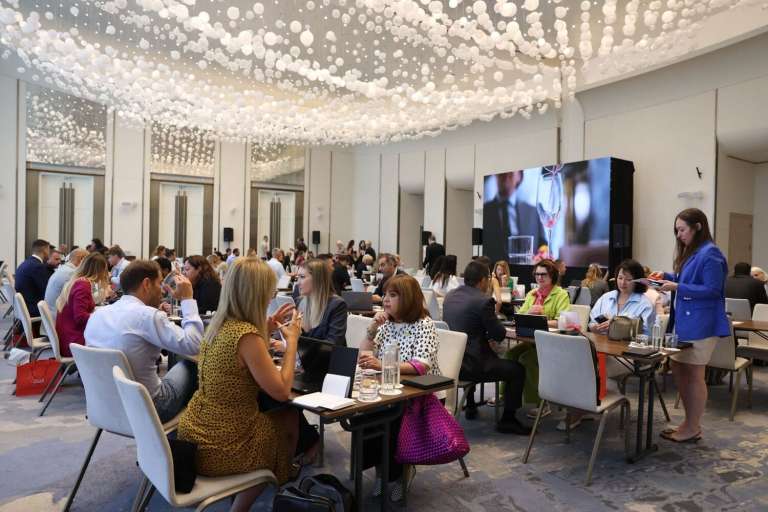 International travel advisors participating in structured B2B networking tables inside the St. Regis ballroom.